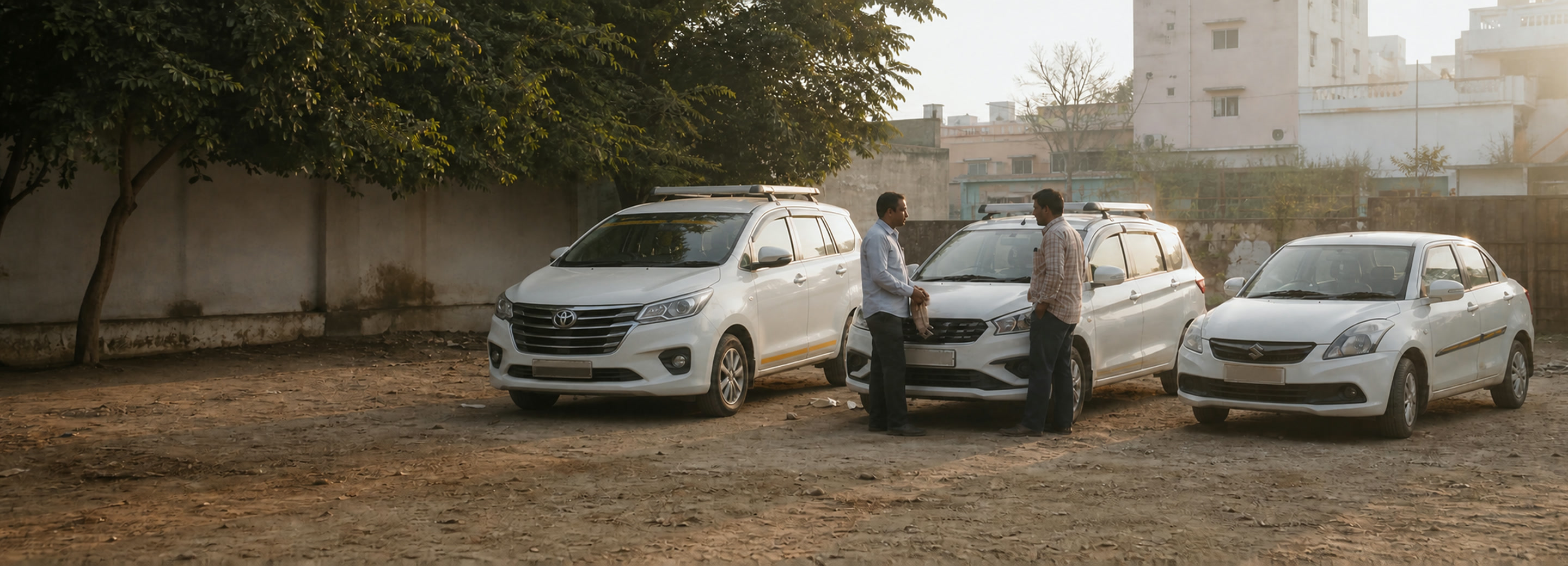 Three SureRide cars and two of our drivers in the Jaipur yard at first light
